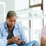 three adults using their phone